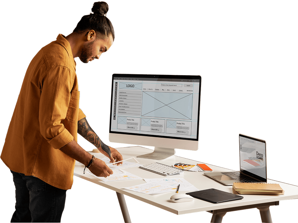 A man is working on a computer with a laptop and a paper, featuring Choose My Site Digital Marketing and aligning with data-driven online marketing solutions.